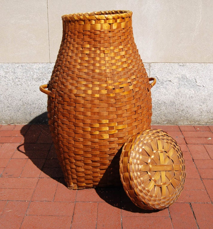 Splint-woven feather basket, a wonderful sculptural form, with two handles and a lid. Originally used for collected down feathers to stuff a bed or comforter.