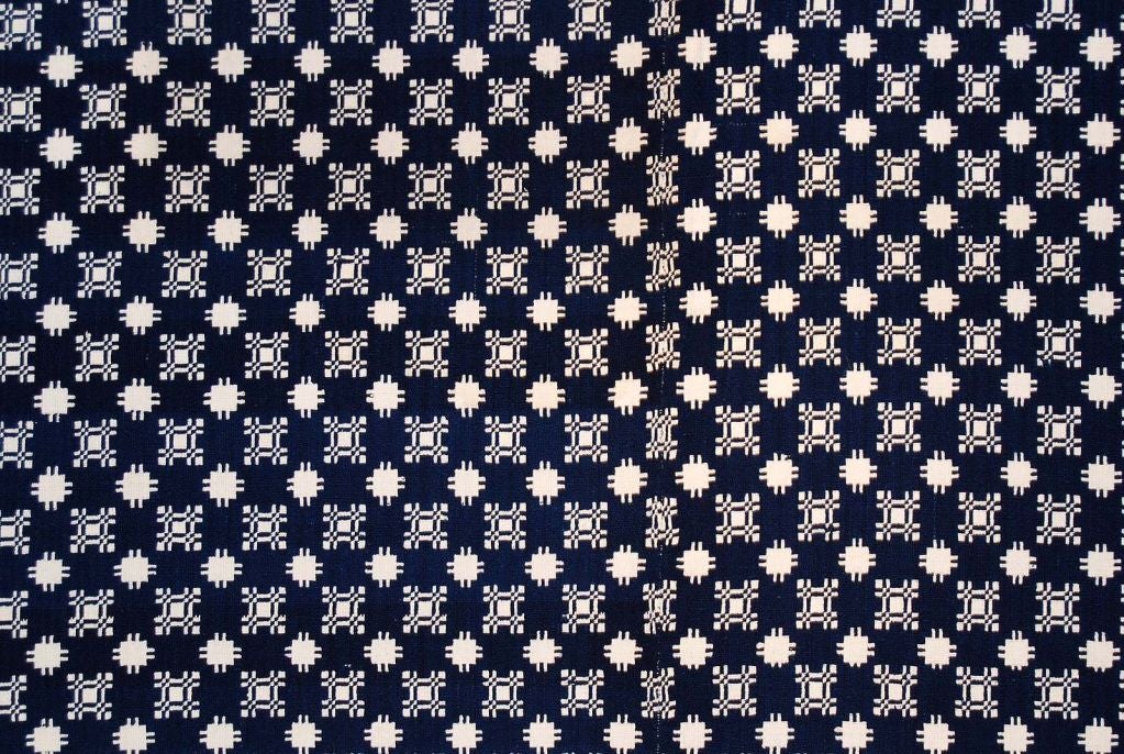 Excellent deep indigo and off-white double-weave coverlet with pinetree border, two pieces with a seam down the middle and fringe on three sides, fully reversible; initialed M.B., New England, circa 1820