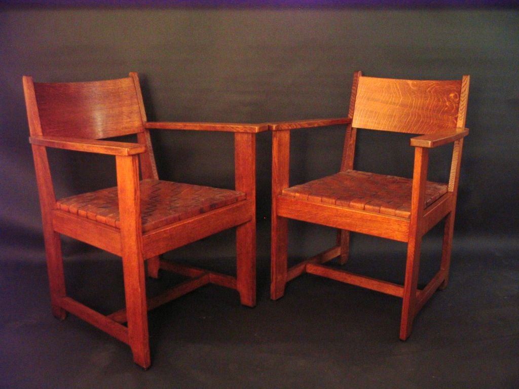 A set of four American Mission or Arts & Crafts Armchairs,<br />
Four chairs in a medium dark fumed oak. This set has a MacIntosh inspiration as well as a Charles Stickley approach using wide boards giving the chair a cut out look.Beautiful
