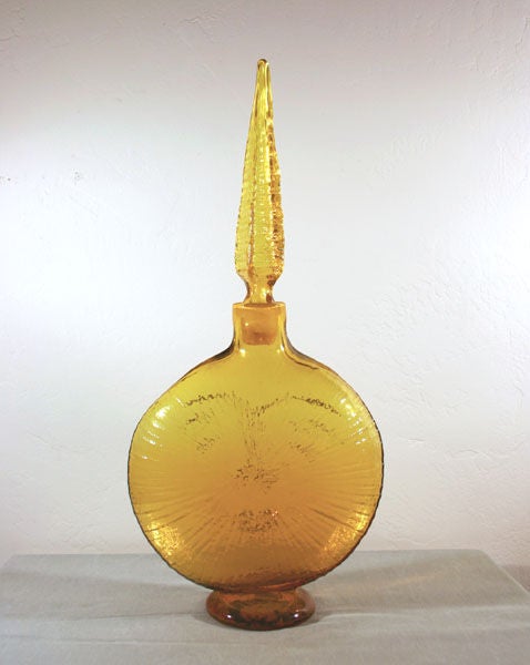 Designed by Wayne Husted for the 1962 Blenko Glass catalog in bright Jonquil yellow (shows more honey tones in picture than is really there).  Nicknamed the “Omnibus” decanter in reference to the period PBS TV series intro graphic which it