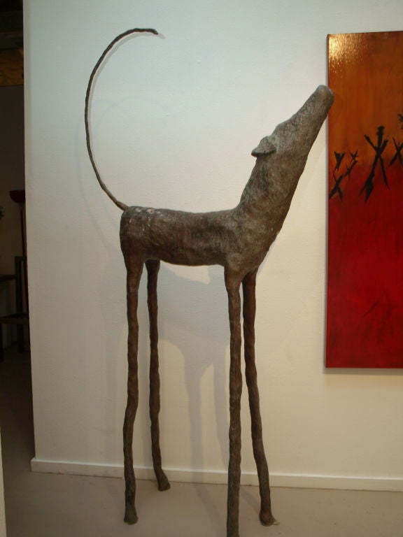 Artist; Jim Budish, bigger than life size dog he calls; “Zoe”, sculpted out of bronze using the lost wax method from an limited edition of 99.  <br />
<br />
Not completely certain if it is the exaggerated legs that tower the animal or the tail