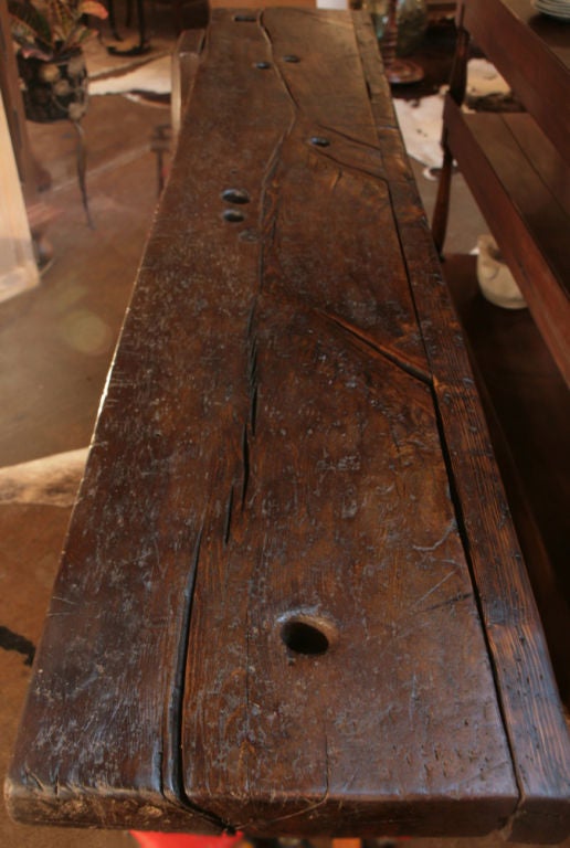 Beautiful antique French carpenter's work bench in solid chestnut and solid cherry wood with original iron fixtures. Width to fixture is 24