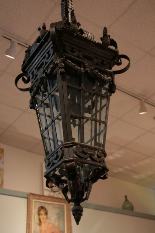 Spectacular pair of Liberty style Parisian forged iron lanterns with glass panes.
