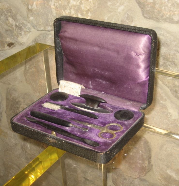 Vintage manicure kit from the 1950's. Metal and plastic with purple satin and velvet interior.

Nail kit includes nail brush, scissors, nail buffer, nail powder, nail cleaner, and cuticle remover.
