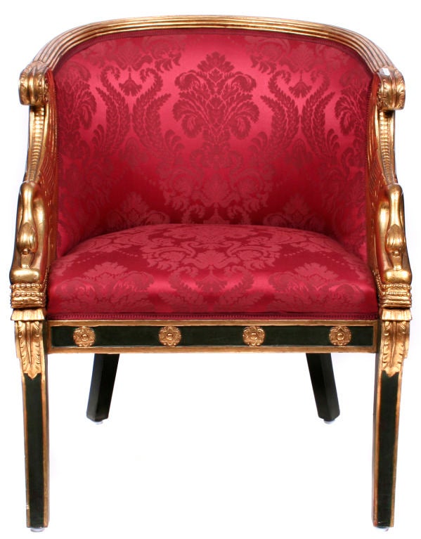 A pair of second empire chairs with exquisitely carved gilded swans on sabre legs.