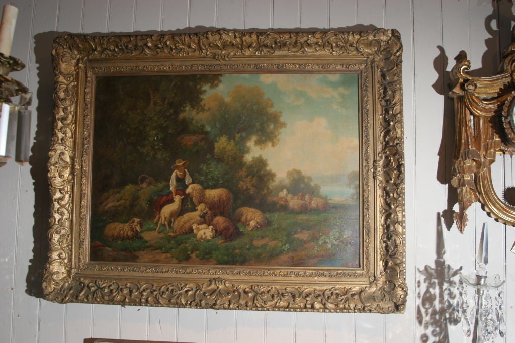 A fine oil on canvas of a shepherdess and her flock in a bucolic landscape. Carved wood frame. Signed lower left Reinhardt. Louis Reinhardt, 1849-1870.