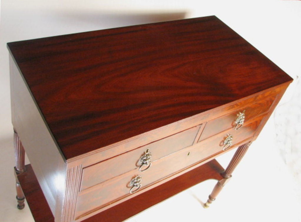 Very fine Sheraton carved mahogany server, with rectangular top with triple reeded edge, above a conforming case with two short drawers over one long drawer, flanked by stop fluted stiles continuing to bulbous turned and reeded legs with a