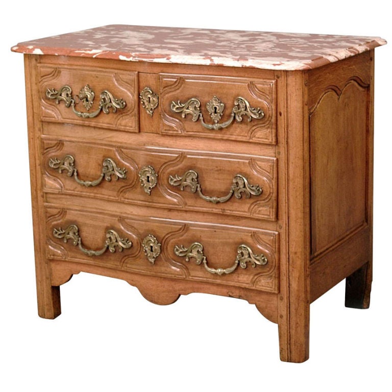 French Rustic Parisian Regence walnut marble top commode, c. early 1700s. The shaped marble top over two small raised and recessed panel drawers above two long raised and recessed panel drawers.  The shaped apron raised on rounded rectilinear