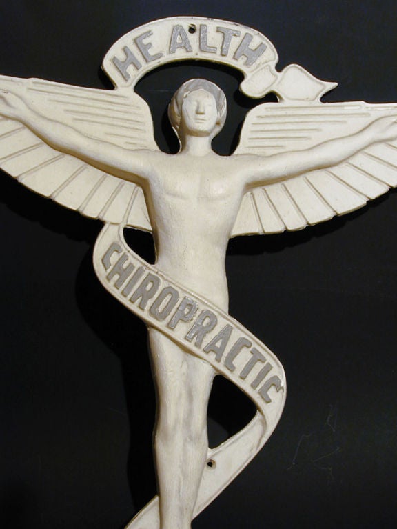 This classic example of trade signage featuring a nude male angel figure with outspread wings was cast in aluminium and painted a shade of off-white. It has all the charm of classic Folk Art and advertising art from the late 19th and early 20th