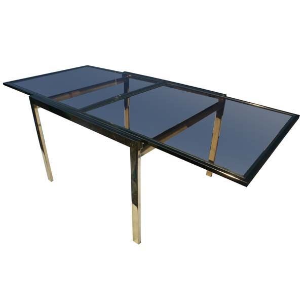 A mid century modern brass extension dining table and four chairs designed by Milo Baughman for Thayer Coggin in the 1970's.  The table expands to 84