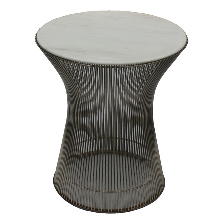 A pair of mid century modern side tables designed by Warren Platner for Knoll originally in 1966.  These are newer examples.  Nickel plated wires base with calacatta marble tops.