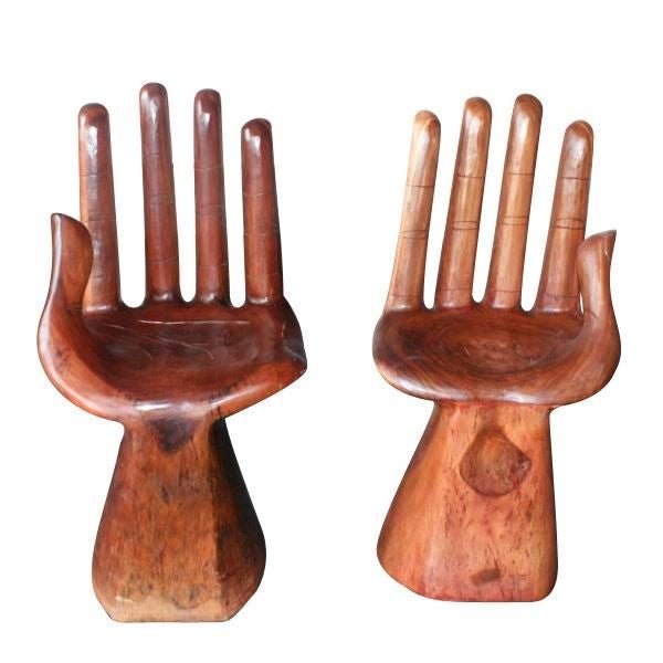 A pair of wooden chairs somewhat in the style of Pedro Friedberg.  One of the chairs is modelled in the shape of a left hand and one as a right hand.