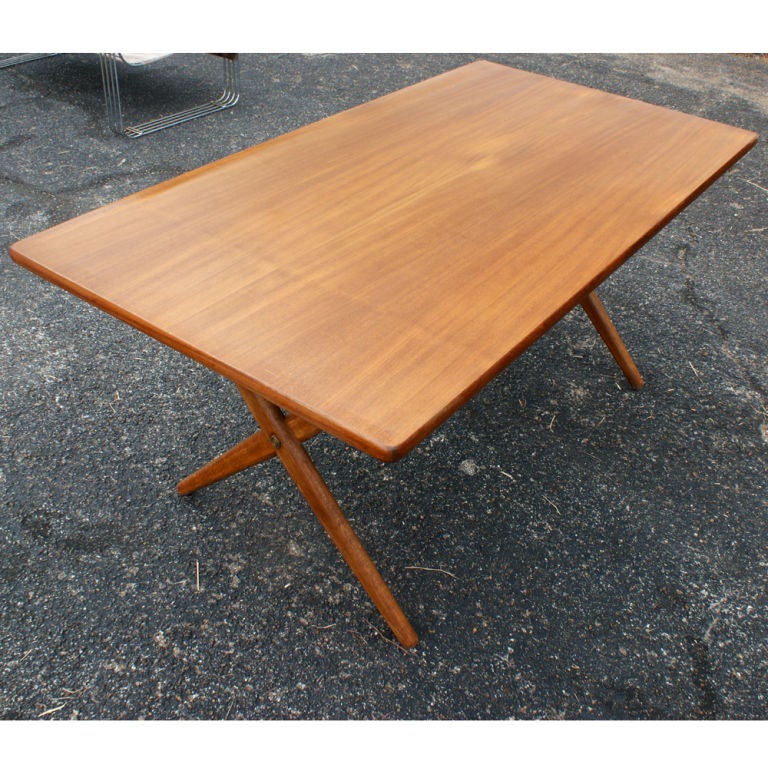 A Scandinavian mid century modern dining table designed by Hans Wegner for Andreas Tuck of Denmark. Model AT-303<br />
Signed:<br />
FABRIKAT: ANDR TUCK <br />
ARKITEKT: HANS J WEGNER <br />
DANMARK