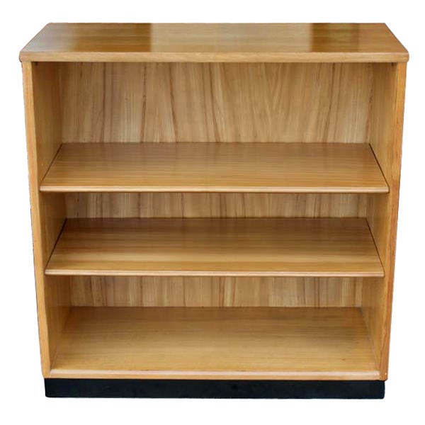 An Edward Wormley designed Mid-Century Modern bookcase from the Precedent Collection by Drexel. Wood construction with two adjustable shelves and ebonized wood base. Model 230-2.