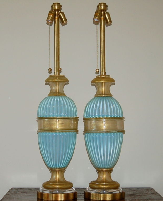Extremely rare pair of Venetian glass lamps from The Marbro Lamp Company in a soft sky blue opaline loaded with gold inclusion. An extremely elegant matched pair.

These lamps measure 39 inches high from tabletop to top of sockets. As shown, the