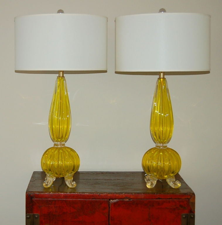 Extremely rare YELLOW OPALINE Murano glass table lamps by Archimede Seguso.  Classic four footed design with vertical ribs.  The feet and connector rings have 24kt GOLD inclusion.

The lamps are 27 inches to the top of the socket.  As shown, the