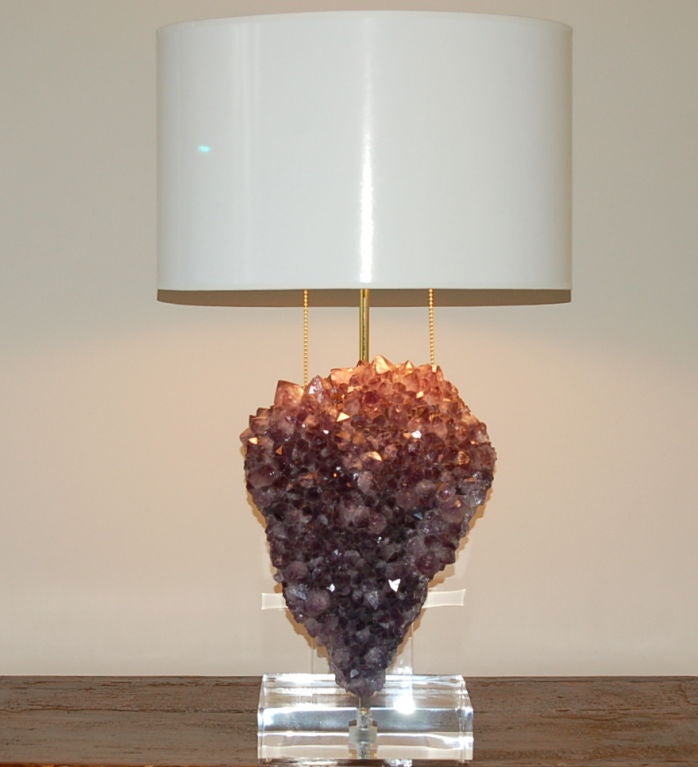 Beautiful table lamp made from heart shaped specimen of AMETHYST mounted on a Lucite base with solid brass figurine mount hardware by Swank Lighting. The Amethyst piece is quite heavy, and brilliant with texture and optics!

The lamp measures 24