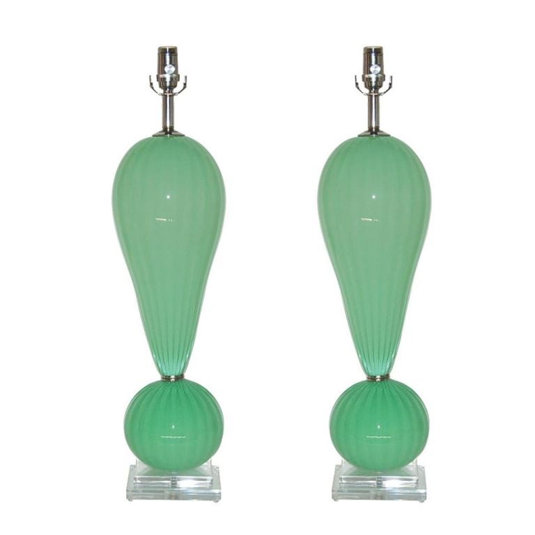 Matched pair of handblown glass table lamps In MINT GREEN by California artist Joe Cariati. Each lamp is signed and year dated by the artist.

They stand 29 inches from tabletop to socket top, (the glass pieces alone total 22 inches). As shown, the