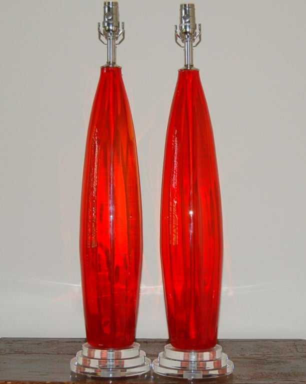 These imposing vintage Italian bullet lamps are a sizzling hot CHILI PEPPER RED.  We show these on Lucite discs with nickel plated hardware. 

They stand 32 inches to the top of the socket.  As shown, the top of shade is 38 inches high. 