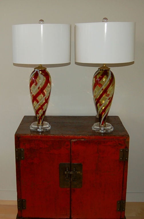 BUTTERSCOTCH Murano glass lamps with RED and WHITE candy cane striping mounted on double platter Lucite bases.  Classic teardrop design taken up a notch. 

The lamps stand 24 inches high, from tabletop to socket top.  As shown, the top of shade is