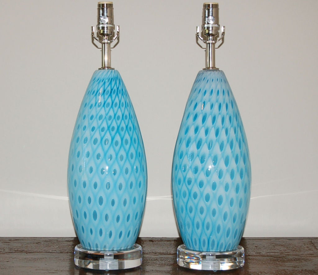 Blown by Galliano Ferro in the 1950's these beautiful BABY BLUE lamps are in Ferro's trademark peacock feather design.  As the technique used to create this effect was so difficult and never copied by other glass artisans, they are extremely rare. 
