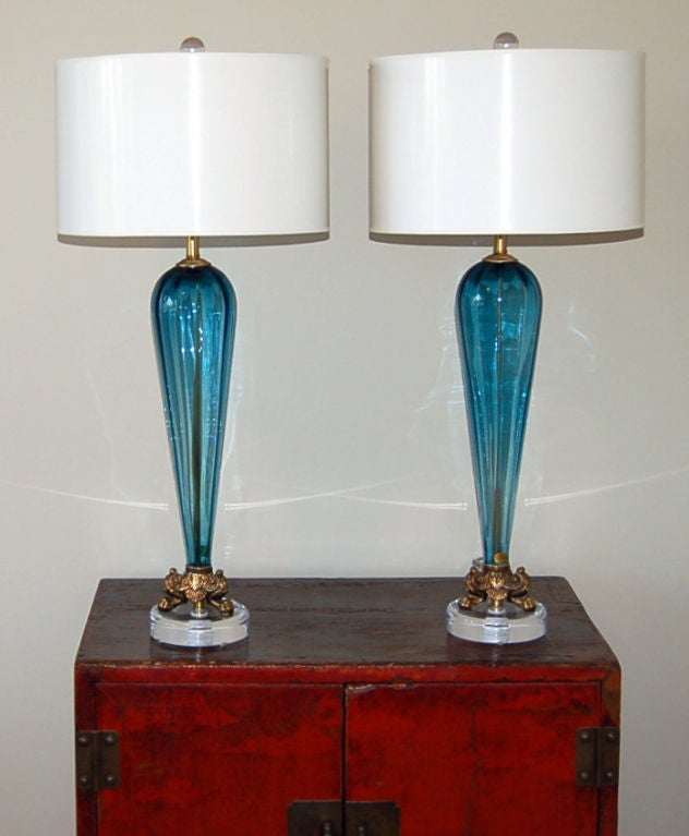 Softly ribbed vintage Murano lamps mounted on lucite base with original tripod feet.<br />
<br />
26