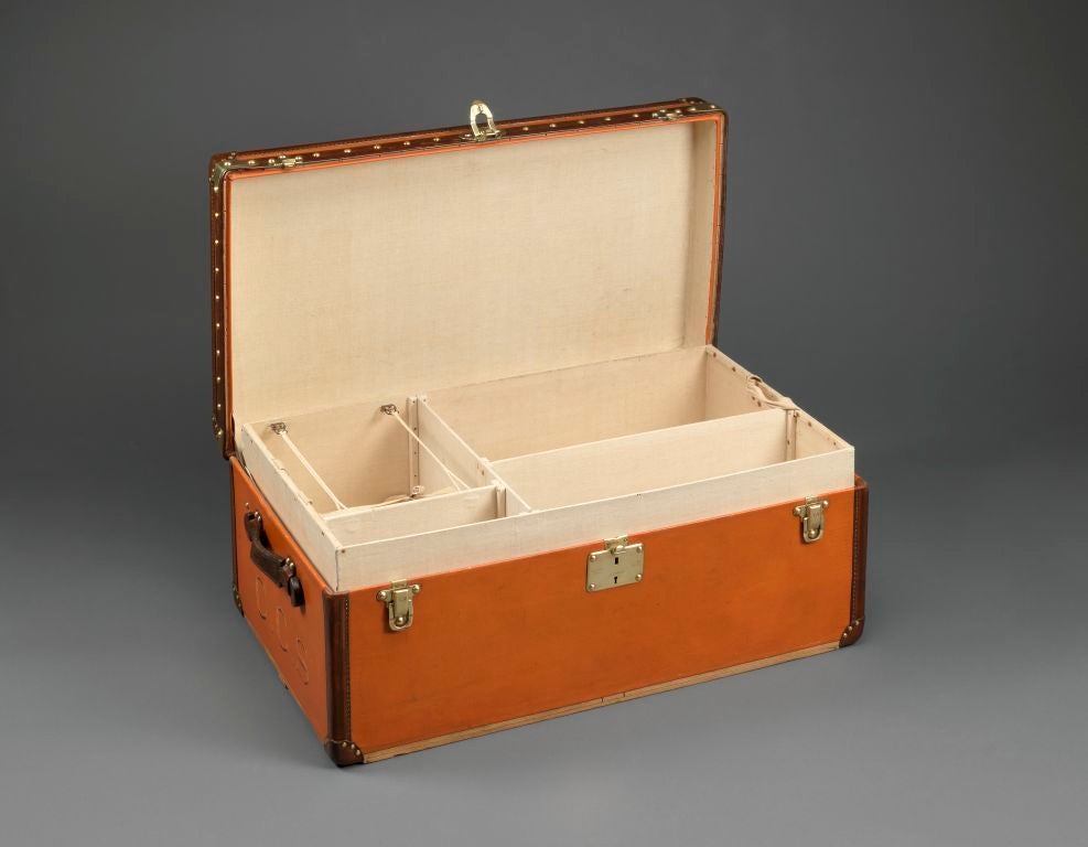 An exceptionally rare ‘Malle Aero’ (Aeroplane Trunk) in orange Vuittonite canvas with leather and brass trim, with near mint-condition interior. <br />
	                                                                                               