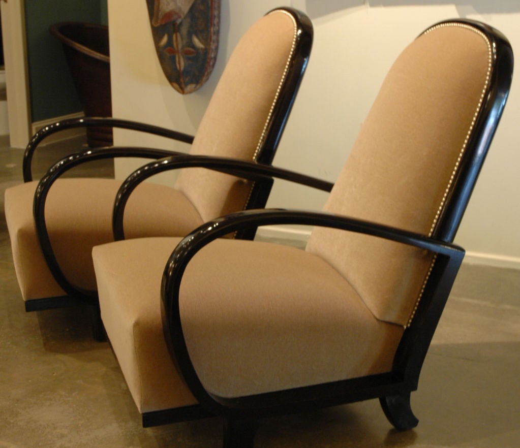 Wonderful pair of large size Hungarian Art Deco chairs.  Black lacquer over beech.  Chairs have been completely restored internally to American standards with beautiful new beige mohair upholstery and silver nail heads.