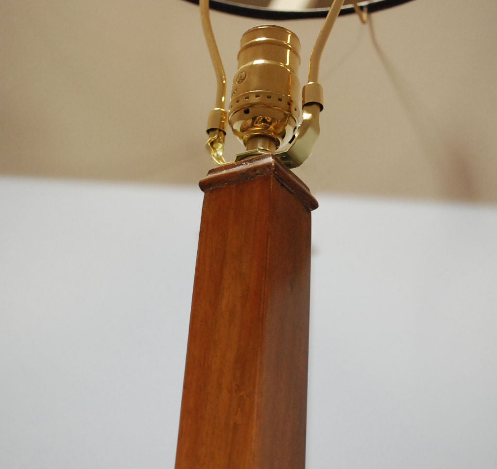 Danish Biedermeier floor lamp, a molded frieze on a squared column tapering out to a square molded base on ebonized bracket feet.