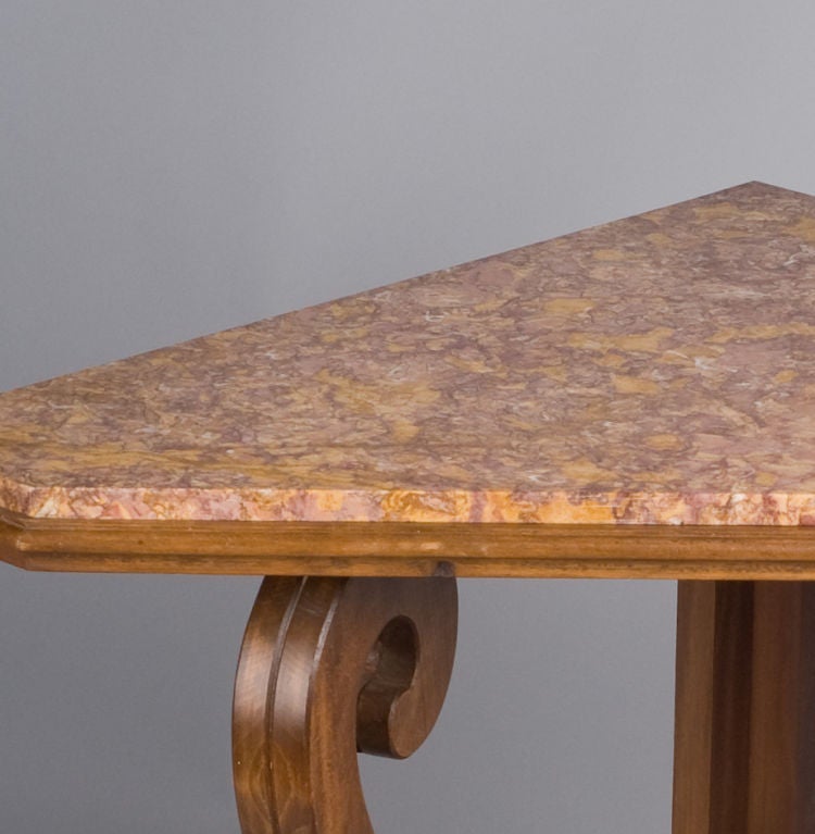 An unusual Corner Table from the Art Nouveau Period, made of walnut and beech wood with a marble top. This triangular Table has scrolled legs and a bottom shelf.