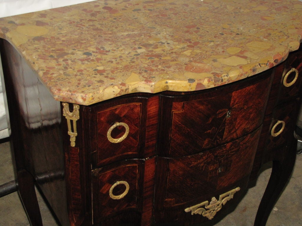 Louis XV marble-top commode, the breche d'Alep marble top above a conforming case with two drawers, bronze pulls and escutcheons, shaped apron with bronze mount and raised on cabriole legs.

After 43 years of business we are retiring. Everything