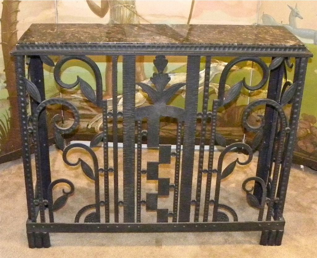 Here's a  beautiful Art Deco Iron Console that can also be utilized as a radiator cover.  In fact it will quickly transform your common radiator into a thing of beauty.  It is made of hefty and enduring wrought iron with a dark gray/dark graphite