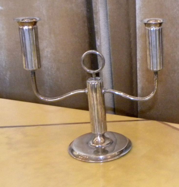 Here is a fun pair of very well designed candlesticks. They are from Argentina marked 925 silver. The design is very

sophisticated, with nice metal work showing off the fluting all around the candle holders and echoed in the main vertical base as