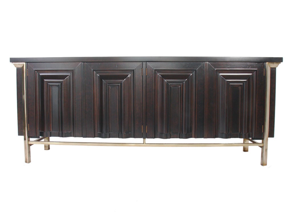 Large Scale Modernist Credenza, circa 1960s. Refinished in an ultra deep brown lacquered burled wood, with hand polished brass trim. The ivory colored inset marble tops exhibit wonderful bookmatched graining. This piece is a versatile size and can
