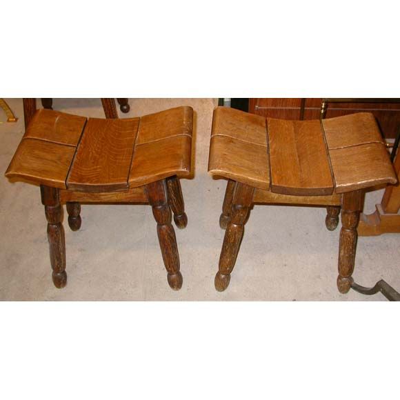 3 carved oak stools by Charles Dudouyt with the seat sectioned in 5 curved pieces mounted on gouged legs.