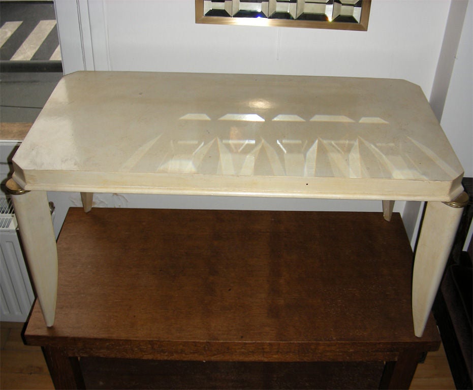 1940's Parchment covered Wood Coffee Table by Maurice Jallot.
The Saber Turned Legs end  with Gilt Bronze Fittings at the Top.