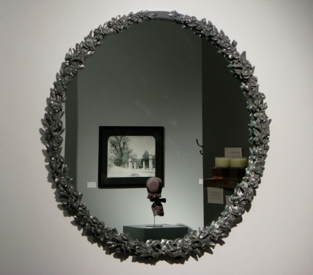 Large wood and plaster mirror<br />
original thick glass, plaster casted rosettes and bow<br />
American circa 1940's, Dark Grey paint<br />
36