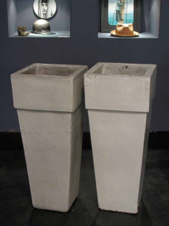 Set of four tall white ceramic glazed planters.<br />
<br />
Heir Antiques<br />
617-216-0839<br />
tyler@heirantiques.com