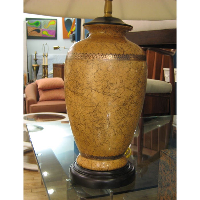 Crackling ceramic glaze table lamp with gold gild bandings. Atop ebonizes walnut base.

