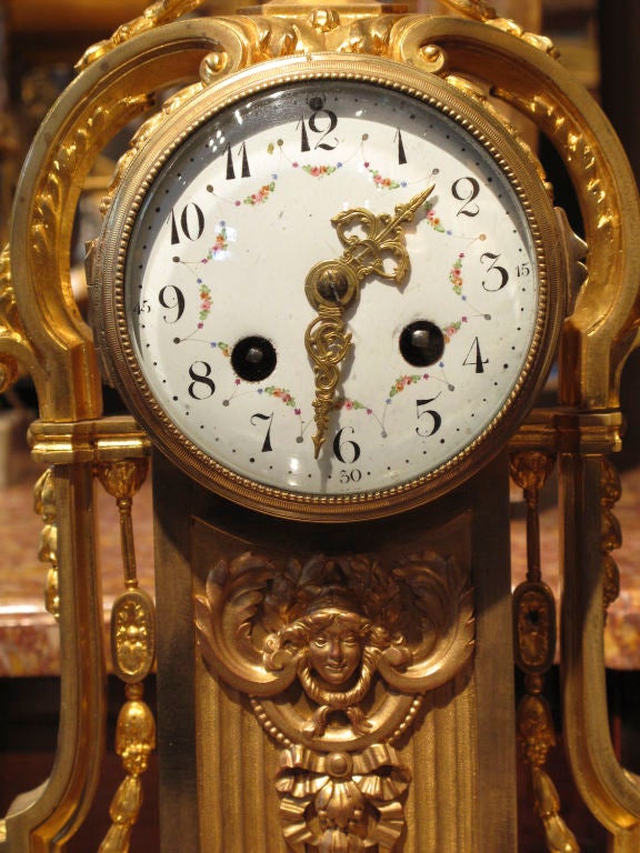 Fine Gilt-Bronze Louis XVI style mantle clock on a white marble base. Signed 