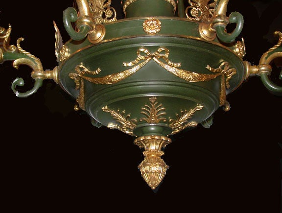 Empire style gilded and patinated bronze six light converted gasolier, hanging from central acanthus crested crown on three rods, leading to central garlanded body that is topped with bronze eagle on globe, and encircled by classically shaped