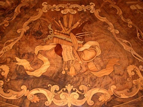 This Centre or Breakfast table has a central medallion of three cherubs and profusely inlaid with trophies emblematic of the Arts and Sciences on a floral and leafy inlaid ground. The quality of the the marquetry is apparent in the photos. The