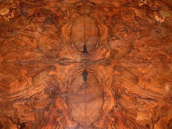 Victorian walnut and marquetry oval center table with bookmatched burled walnut top and inlaid floral and foliate border, on central quadripod base, adapted to coffee table height.