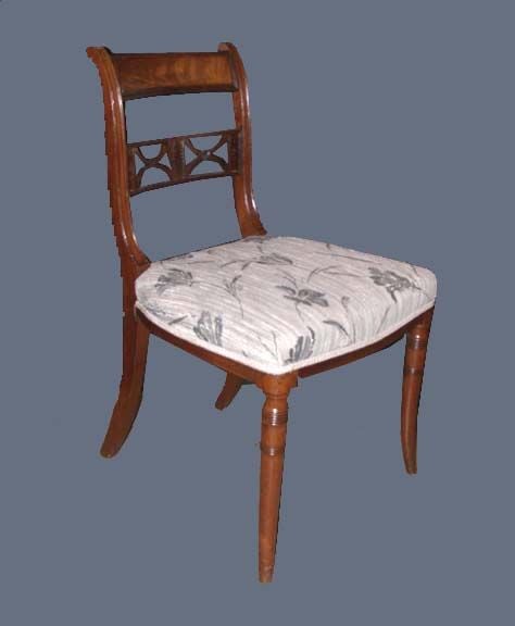 Assembled set of twelve Regency period mahogany bar back dining chairs over divided splats joined by reeded bar flanked by xes over upholstered seats supported in front by turned and tapered legs.
