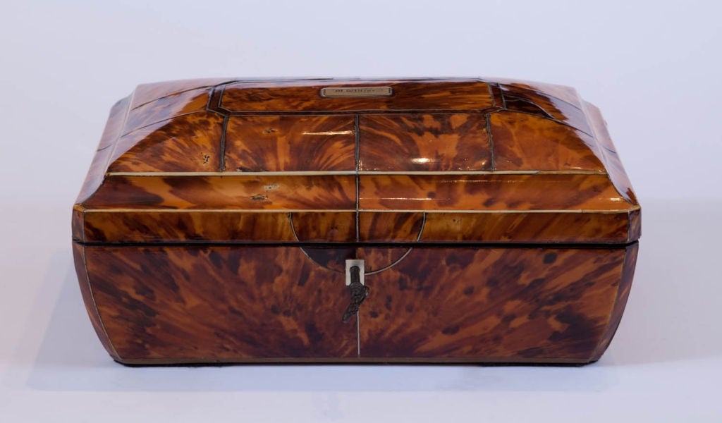 An exquisite 19th century, French tortoise shell sarcophagus-form sewing box with lion-mask ring handles, the cover with bone and silver stringing and silver cartouche monogrammed “M. Wilcox.