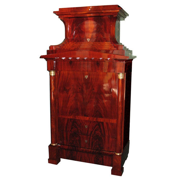 Exemplary North German Biedermeier fall front secretaire (usable as a standing desk and lectern). Book match crotch mahogany on pine, architecturally designed with freestanding columns, stepped top with Schinkel pediment, arched door. Fitted