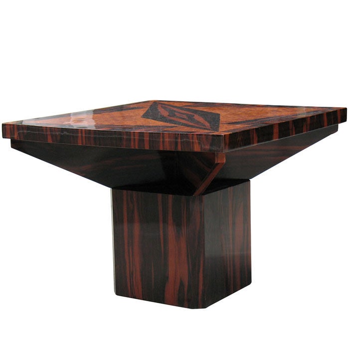 Exceptional French Art Deco side table in the manner of Dominique veneered with amboyna and makassar on beech in magnificent geometrical pattern. Large sized and square shaped table top on angled board supports over canted cubical base.<br />
<br