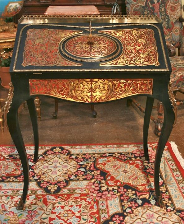 French Boulle desk with brass inlay in tortoise shell with ormolu. Technique developed for Louis XIV by Andre Boulle. Slant top lifts to reveal three drawers and five slots and a secret compartment