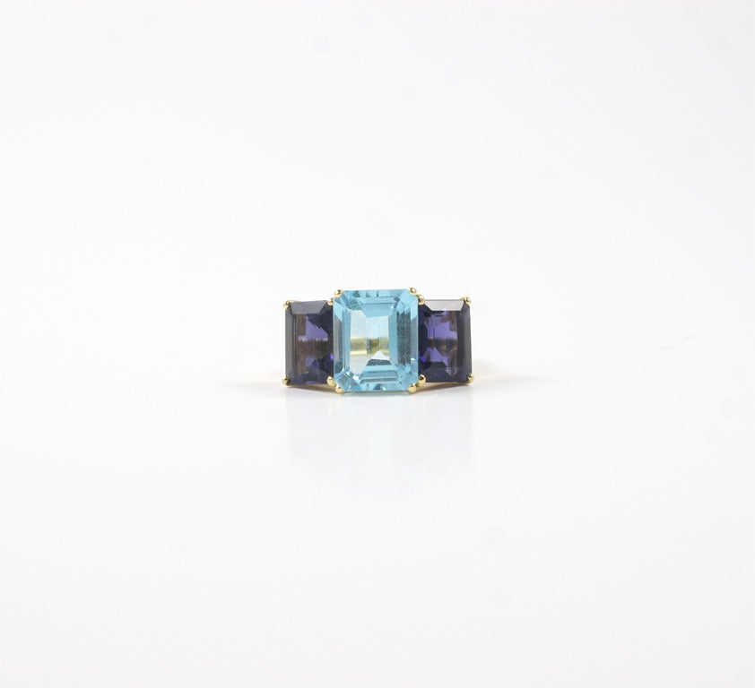 18kt yellow gold Emerald Cut ring with blue topaz (approximately 5 cts) and iolite (approximately 4 cts each).

The Ring measures approximately 1 