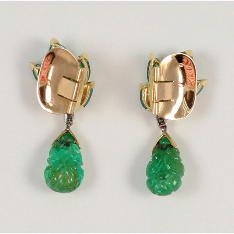 A pair of carved Indian and faceted emerald and diamond gold set earclips by Suzanne Belperron. French hallmarked and bearing the Belperron maker's mark of Groene et  Fils.